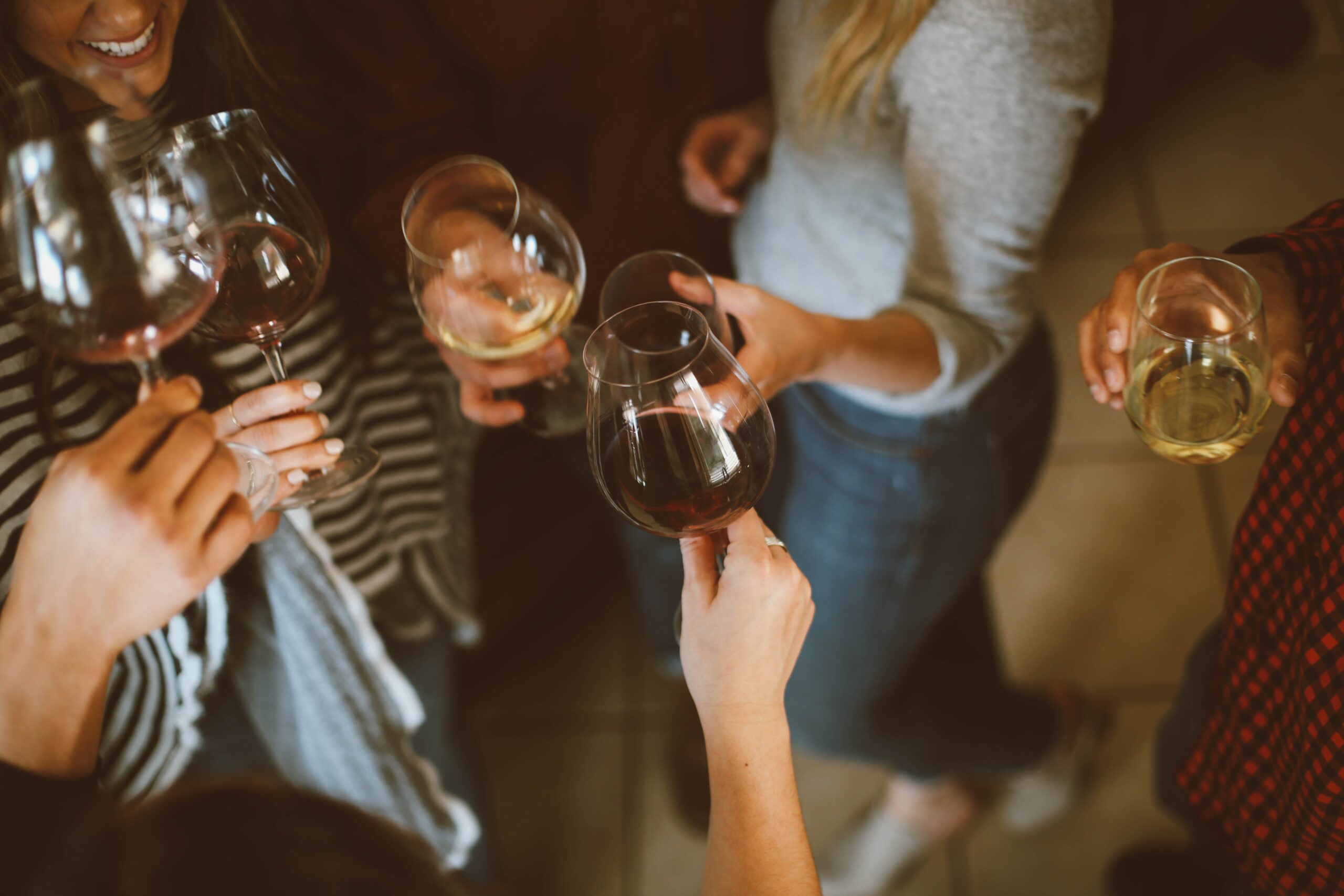 group of people with glasses of red and white wine