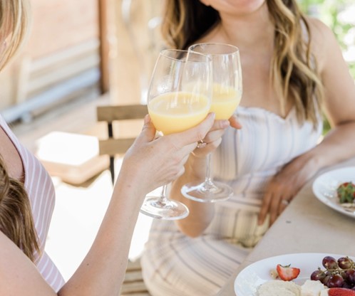 two women toasting with mimosas during Brunch at Waterside Grill and Lounge Restaurant