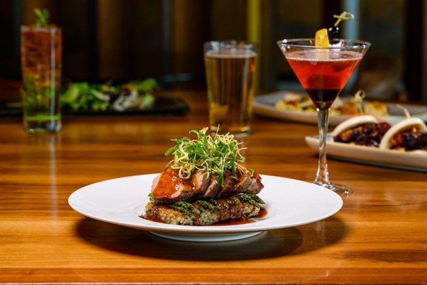 boneless beef short rib next to red craft cocktail from Waterside Grill and Lounge