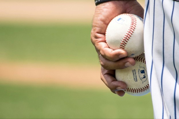 baseball player holding baseballs